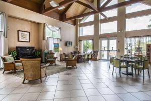 a large lobby with tables and chairs and windows at Bluegreen Vacations Hammocks at Marathon, Ascend Collection Resort in Marathon