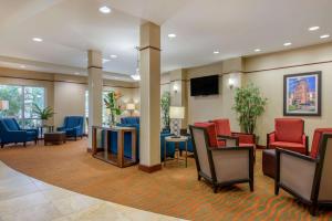 a waiting room with red and blue chairs at Comfort Suites Sarasota-Siesta Key in Sarasota