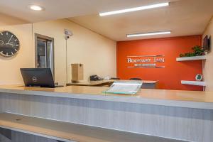 an office with a reception counter with a laptop on it at Rodeway Inn Kissimmee - Orlando Maingate West - Free Theme Park Shuttle in Orlando
