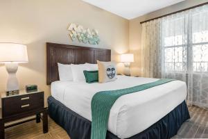 a hotel room with a large bed and a window at Bluegreen Vacations The Fountains, Ascend Resort Collection in Orlando