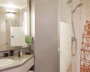 a bathroom with a sink and a shower at B&B HOTEL Albi in Albi +39 photos