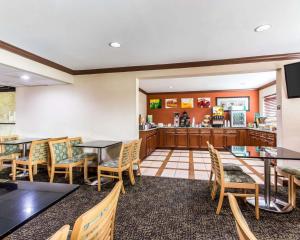 a restaurant with tables and chairs and a counter at Quality Inn & Suites Morrow Atlanta South in Morrow