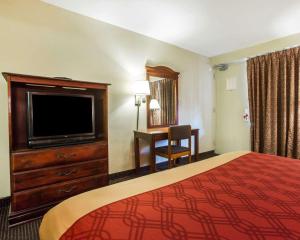 a bedroom with a large bed and a television at Econo Lodge Airport in Atlanta