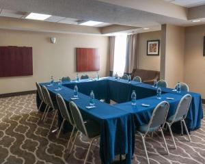 a conference room with a long blue table and chairs at Comfort Inn & Suites in La Grange