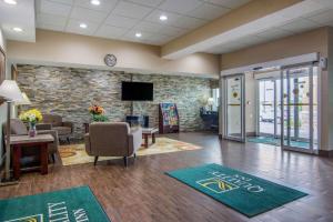 a lobby with a waiting room with chairs and a tv at Quality Inn & Suites Union City - Atlanta South in Union City