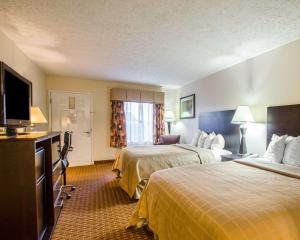 a hotel room with two beds and a flat screen tv at Quality Inn Dahlonega Near University in Dahlonega