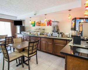 a kitchen with a table and chairs and a counter at Quality Inn Dahlonega Near University in Dahlonega