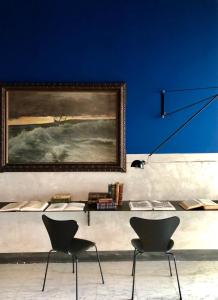 a room with two chairs and a painting on the wall at PrimoPianoPosillipo in Naples