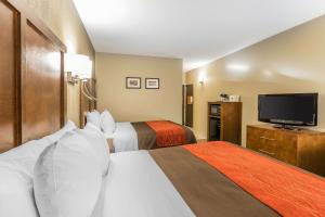 a hotel room with two beds and a flat screen tv at Comfort Inn & Suites Dalton West in Dalton +19 photos