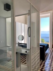 a bathroom with a desk and a view of the ocean at PrimoPianoPosillipo in Naples
