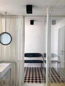 a bathroom with a shower and a sink and a mirror at PrimoPianoPosillipo in Naples