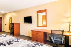 a hotel room with a desk and a chair at Sleep Inn & Suites in Athens