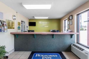 a lobby of arothnian inn with a reception counter at Rodeway Inn in Augusta