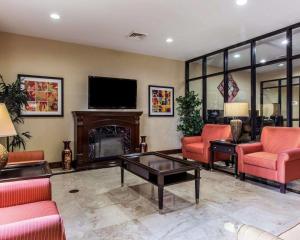 a living room with a fireplace and a flat screen tv at Comfort Suites Waycross in Waycross +22 photos