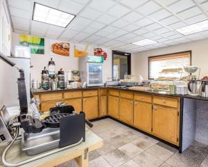 a kitchen with wooden cabinets and a counter top at Quality Inn in Macon