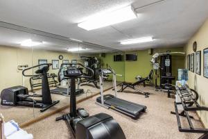 a gym with several tread machines and a mirror at Quality Inn Midtown Savannah in Savannah