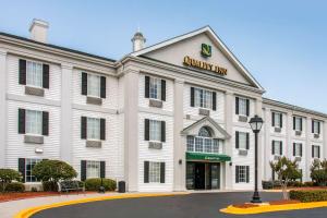 un edificio bianco con un cartello che legge l'auditorium inn di Quality Inn Pooler - Savannah I-95 a Savannah