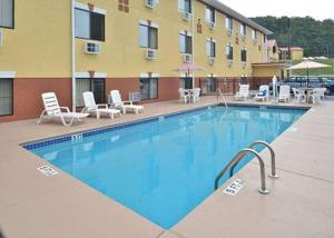 a swimming pool with chairs and a hotel at Econo Lodge Cartersville-Emerson Lake Point in Cartersville