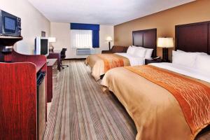 a hotel room with two beds and a flat screen tv at Comfort Inn in Blairsville