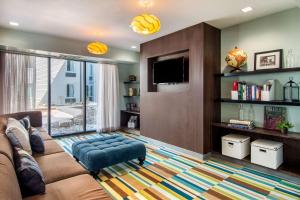 a living room with a couch and a tv at Clarion Inn & Suites Atlanta Downtown in Atlanta