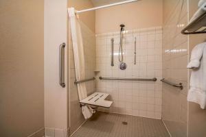a bathroom with a toilet, sink, and shower stall at Quality Inn - Coralville in Coralville
