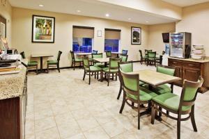 a restaurant with green chairs and tables in a room at Comfort Inn in Blairsville