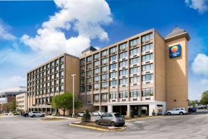 a large building with a car parked in a parking lot at Comfort Inn & Suites Event Center in Des Moines