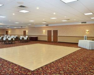 a banquet hall with a dance floor and tables at Quality Inn & Suites Fort Madison near Hwy 61 in Fort Madison