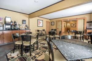 a restaurant with tables and chairs and a bar at Quality Inn & Suites Decorah in Decorah