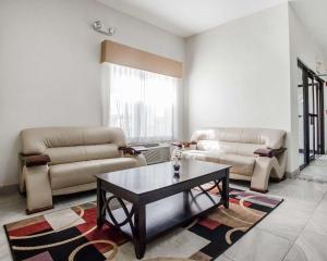 a living room with two couches and a coffee table at Quality Inn & Suites Altoona - Des Moines in Altoona
