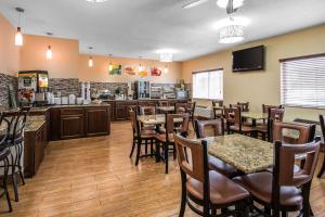 a restaurant with tables and chairs and a bar at Quality Inn Dubuque on Hwy 20 in Dubuque +22 photos