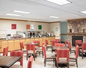 Un restaurante con mesas y sillas y chimenea. en Comfort Suites Airport, en Boise