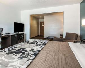 a hotel room with a bed and a flat screen tv at Sleep Inn & Suites Mount Vernon in Mount Vernon