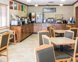 a restaurant with tables and chairs and a kitchen at Quality Inn in Lewiston