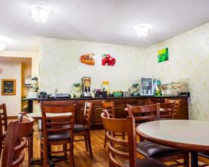a restaurant with tables and chairs and a counter at Quality Inn & Suites in Champaign