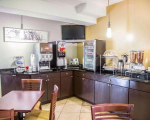 a kitchen with a counter with a table and chairs at Sleep Inn Tinley Park I-80 near Amphitheatre-Convention Center in Tinley Park
