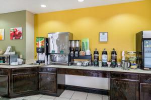 a kitchen with a counter with bottles of alcohol at Quality Inn and Suites Harvey in Harvey