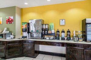 a kitchen with a counter with bottles of alcohol at Quality Inn & Suites near I-80 and I-294 in Harvey