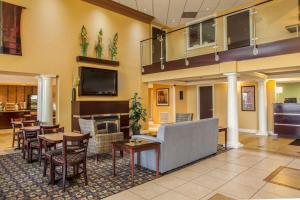 a lobby with a couch and tables and chairs at Quality Inn & Suites St Charles -West Chicago in Saint Charles