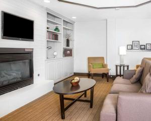 a living room with a couch and a tv at Sleep Inn Midway Airport in Chicago