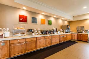 a large kitchen with wooden cabinets and a counter at Comfort Suites in Mattoon