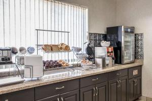 a kitchen with a counter with some food on it at Comfort Suites Peoria I-74 in Peoria