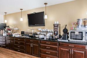 a kitchen with a counter with a microwave and a tv at Sleep Inn Springfield West in Springfield