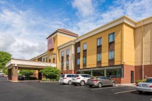 a hotel with cars parked in a parking lot at Comfort Suites Fairview Heights Saint Louis in Fairview Heights