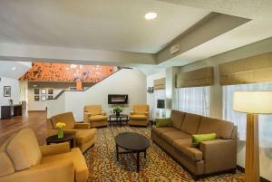 a living room with couches and chairs and a staircase at Sleep Inn & Suites in Danville