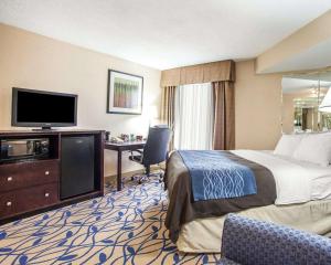 a hotel room with a bed and a flat screen tv at Comfort Inn Bourbonnais near I-57 in Bourbonnais