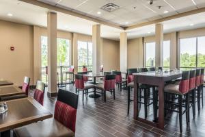 a dining room with tables and chairs and windows at Comfort Inn Edwardsville - St Louis in Edwardsville