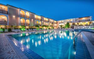 a swimming pool in a hotel at night at Zante Sun Resort in Lithakia