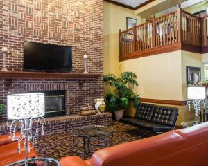 a living room with a fireplace and a tv at Quality Inn Bolingbrook I-55 in Bolingbrook