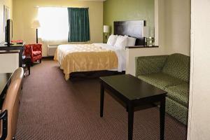 a hotel room with a bed and a couch at Quality Inn Evansville Eastland Area in Evansville